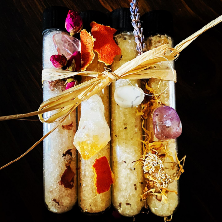 Four decorated sealed tubes of bath salts.